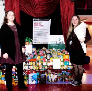 The Food Bank owner Sarah Simons and Little Miss Production's Louise Martin who organised the  Feed Me Music event which was held at The Performance Center, University Falmouth. Sarah had just given a speech about the event to the guests and gave Louise flowers for her efforts.